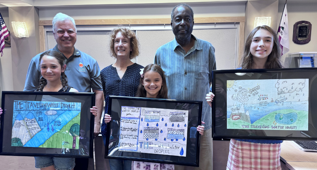 CHWD 2025 Poster Contest Winners with CHWD Board of Directors_web (Back row, L-R): Raymond A. Riehle, CHWD Board President; Caryl F. Sheehan, CHWD Board Vice President; and David C. Wheaton, CHWD Board Director. (Front row, L-R): Sophia Richards, Liliana Hodges, and Lyra Rutherford, CHWD Poster Contest winners.