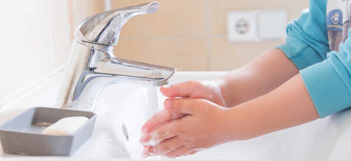 Washing hands in sink